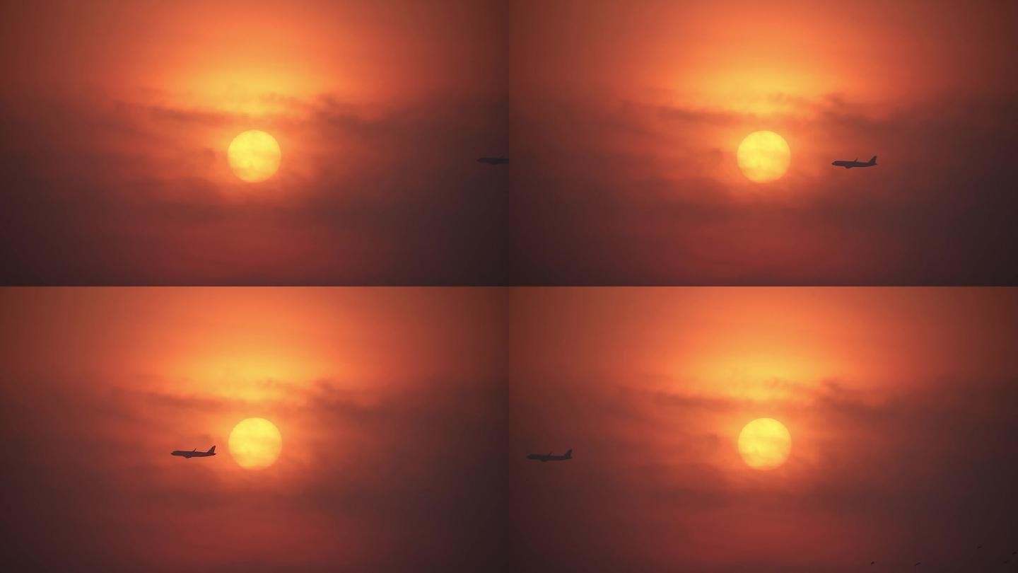 黎明日出时分民航飞机飞过太阳凌日剪影