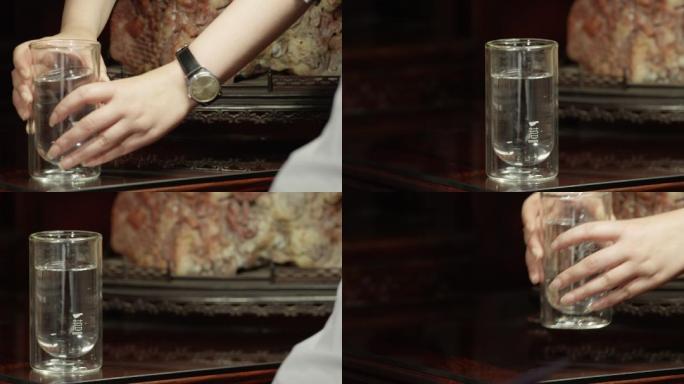 水杯放桌上动作玻璃水杯特写放下水杯