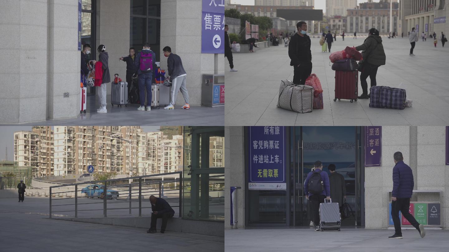 南昌火车站东外等待行人旅客拿着行李