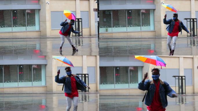 男子手持雨伞在雨中跳舞