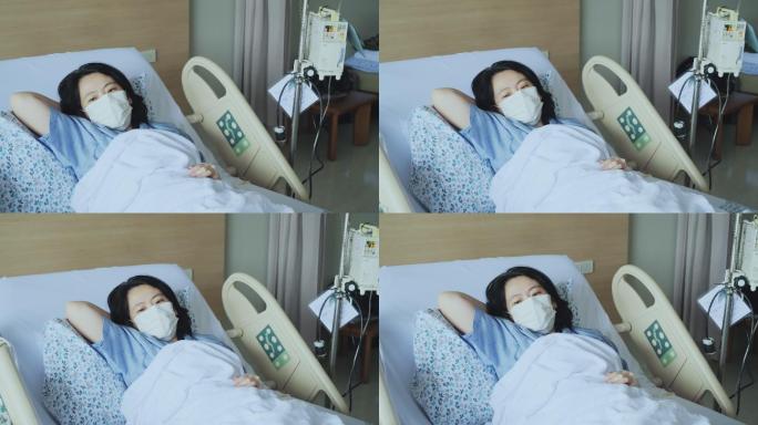 妇女在病床上戴着口罩。