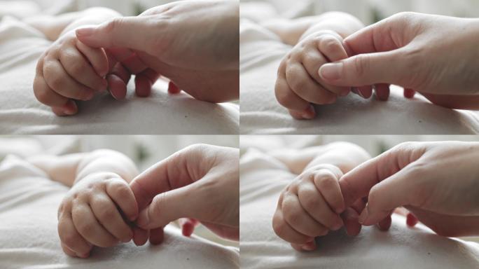 婴儿握住妈妈的手新生慢动作升格镜头紧握抓