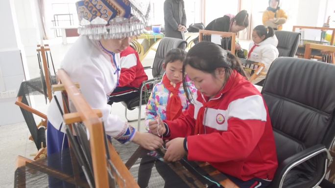 非遗传承人教授学生学习土家非遗西兰卡普