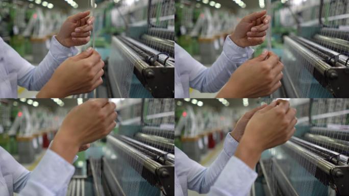 一位妇女在工厂检查机器上的橡胶线
