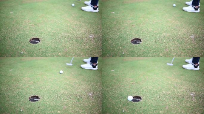 高尔夫球手将球打入球洞的慢镜头特写