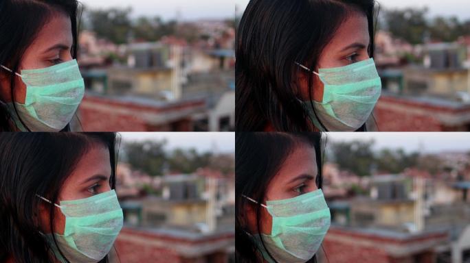 妇女用防污口罩遮住脸，以防感染病毒
