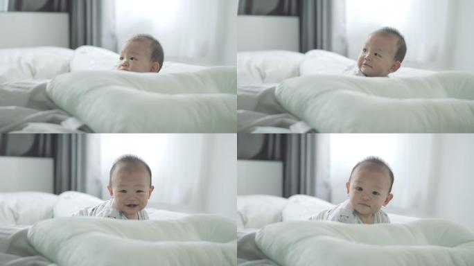 可爱的小男孩在床上爬行