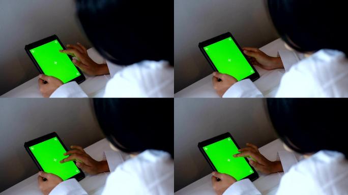 女性使用平板电脑绿屏绿布绿幕抠图后期跟踪