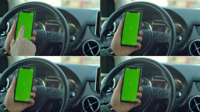 在汽车中，一名男子使用绿色屏幕智能手机