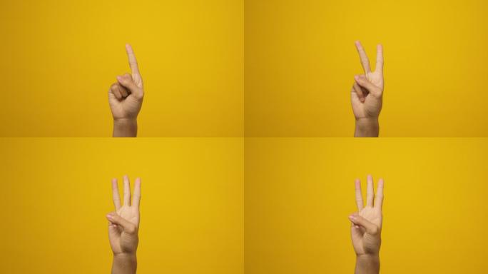 男人用手指显示一、二、三的手势