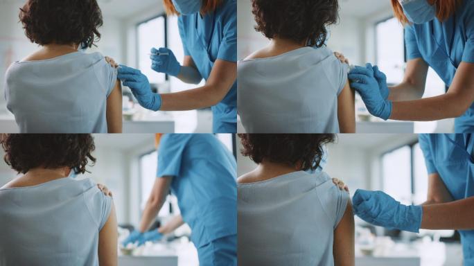 医护人员正在为一名女性患者注射疫苗。