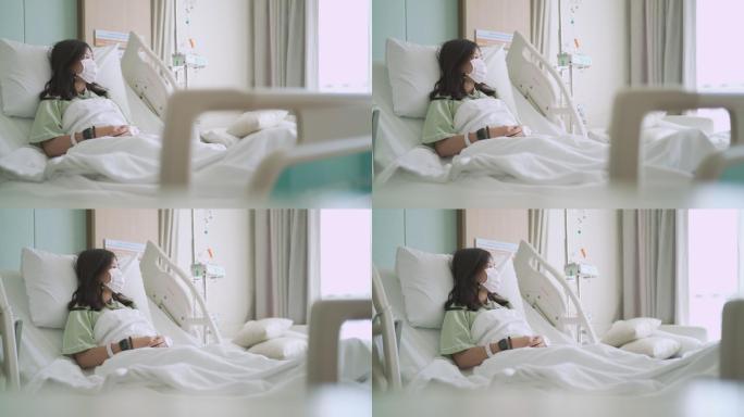 女性患者躺在床上望向窗外白色床单病床点滴