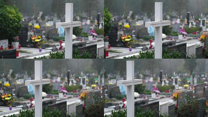 墓地白色十字架上的防护面罩