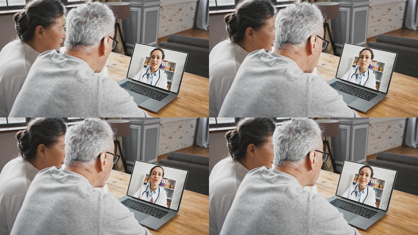 老年夫妇通过视频通话与女医生交谈