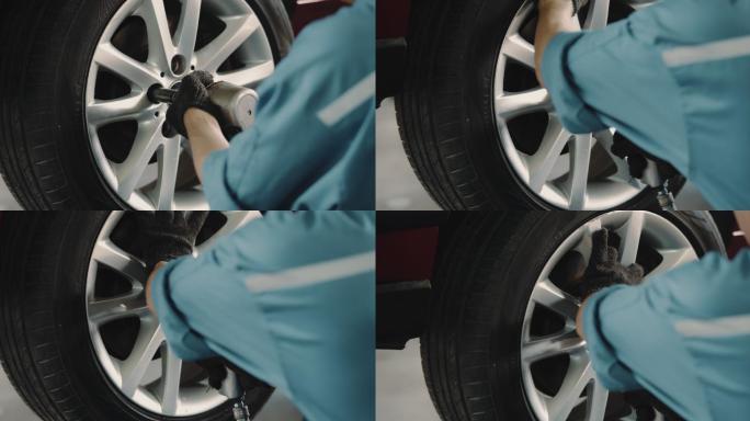 在汽车修理厂更换轮胎的技工