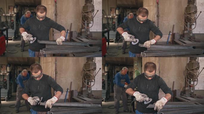 专业焊工在焊接车间打磨金属棒
