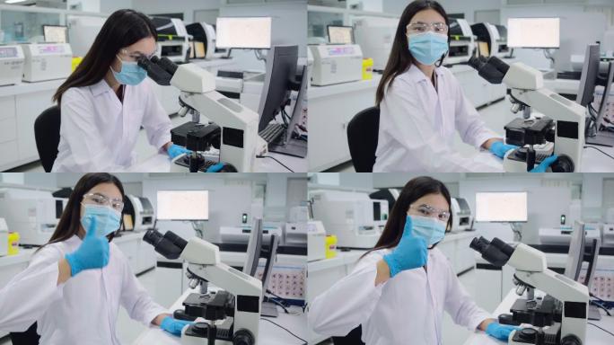女科学家用显微镜观察血小板实验血液样本。