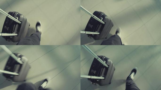 男子在机场步行出差拉行李箱航站楼