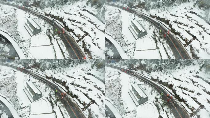 暴雪中道路养护工人除雪作业4K航拍