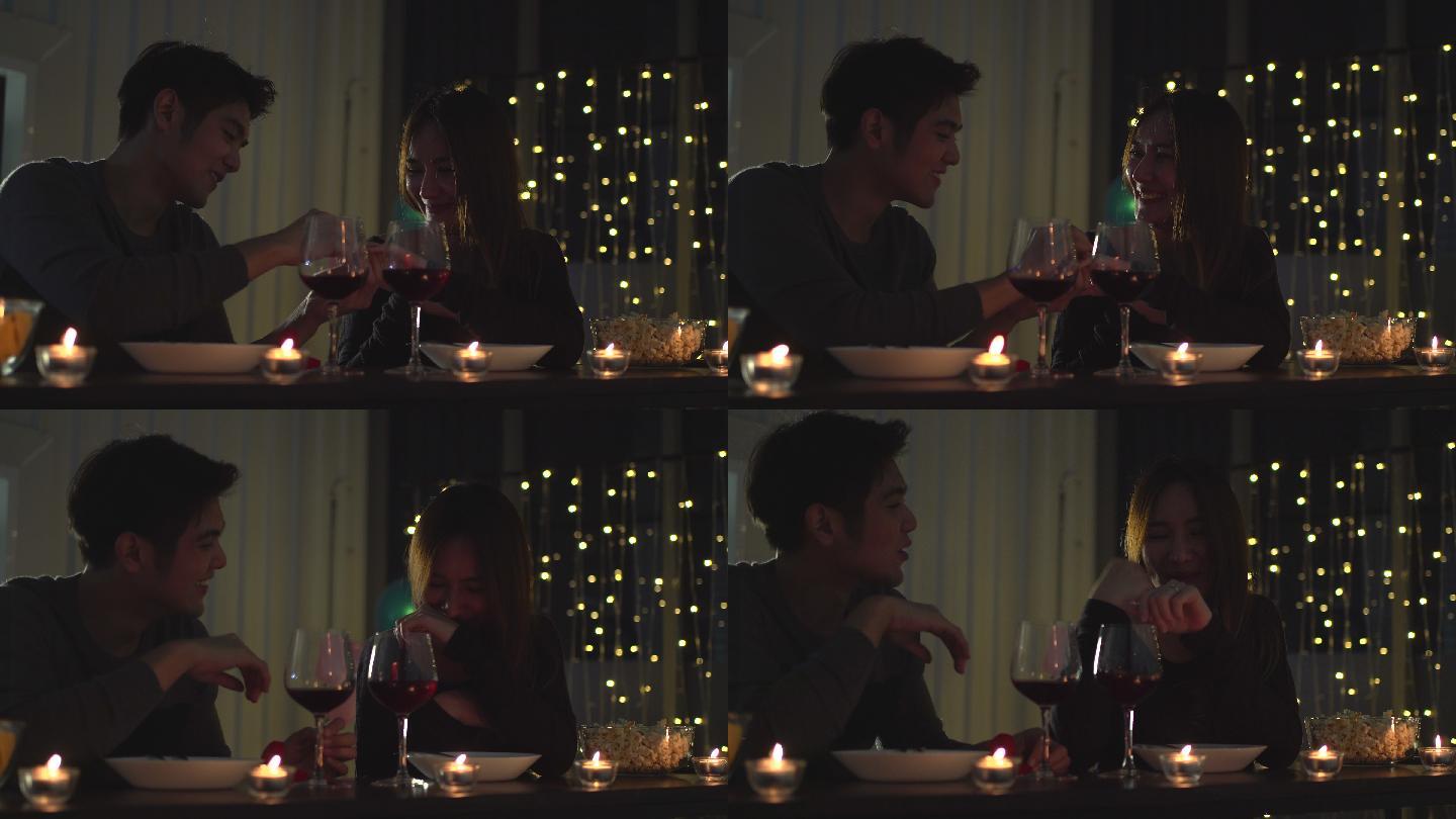 年轻夫妇享受晚餐烛光晚餐浪漫情侣仪式感
