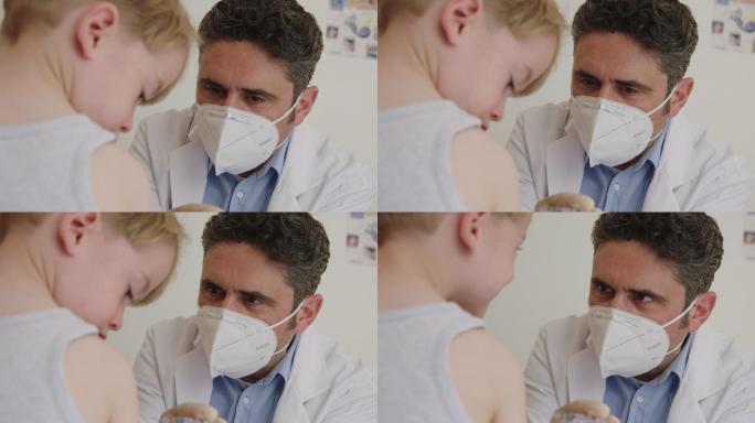 医生给一个小男孩注射疫苗