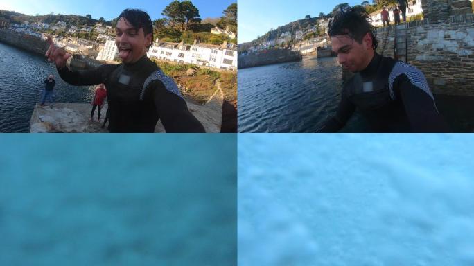 一名男性穿着潜水服从港口跳入大海
