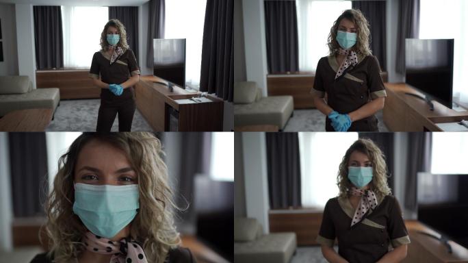 酒店房间里戴着医用口罩和手套的服务员