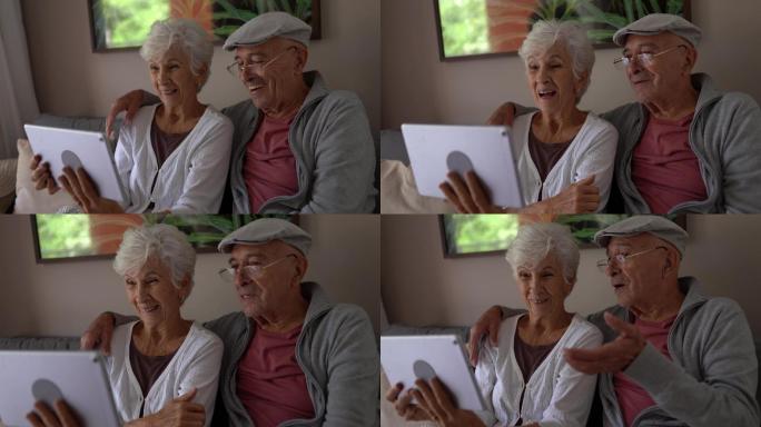 一对老年夫妇在家里用平板电脑进行视频通话