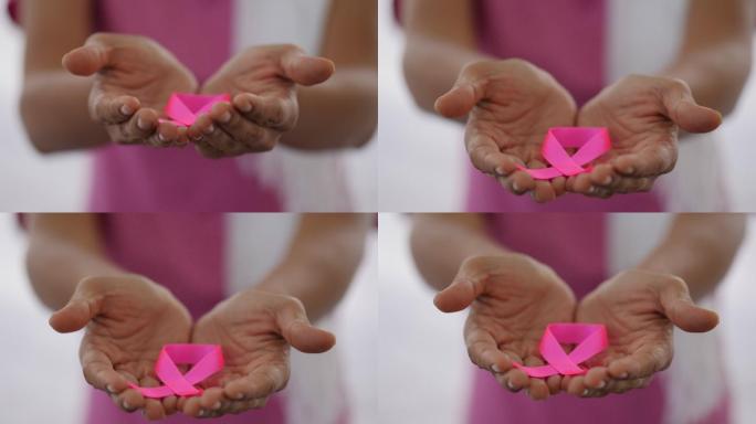 手里拿着一条象征乳腺癌病人的丝带