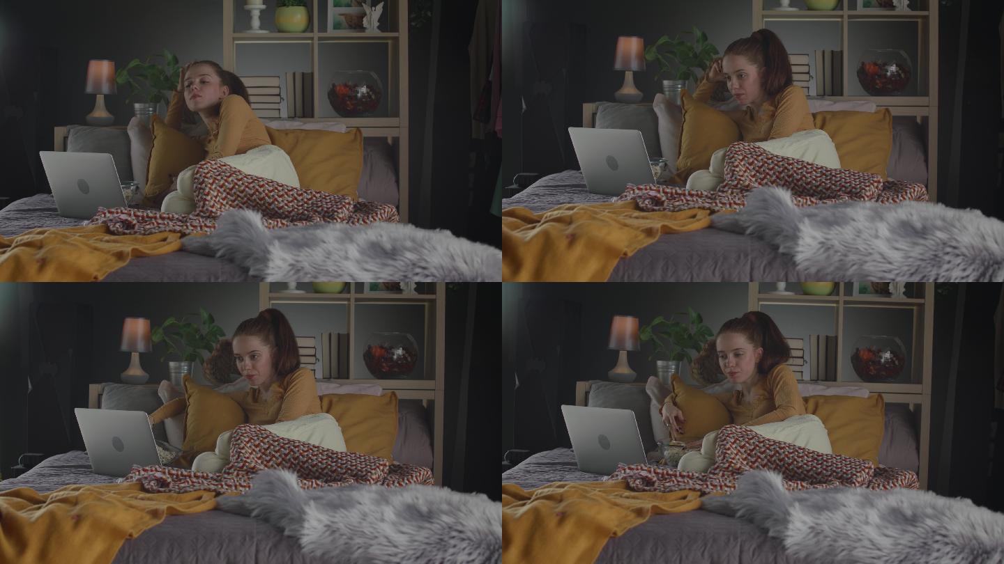 年轻女子在床上用笔记本电脑看电影