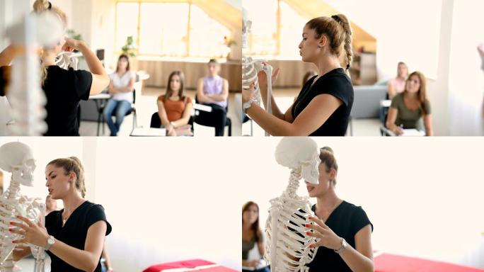 女老师在假骨架上讲解人体解剖学