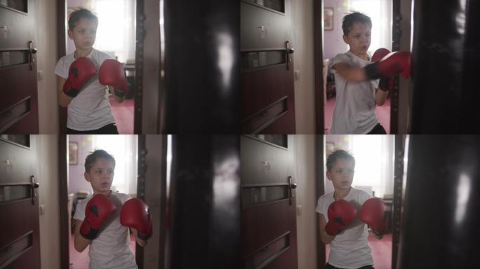 小男孩用拳击袋训练拳击