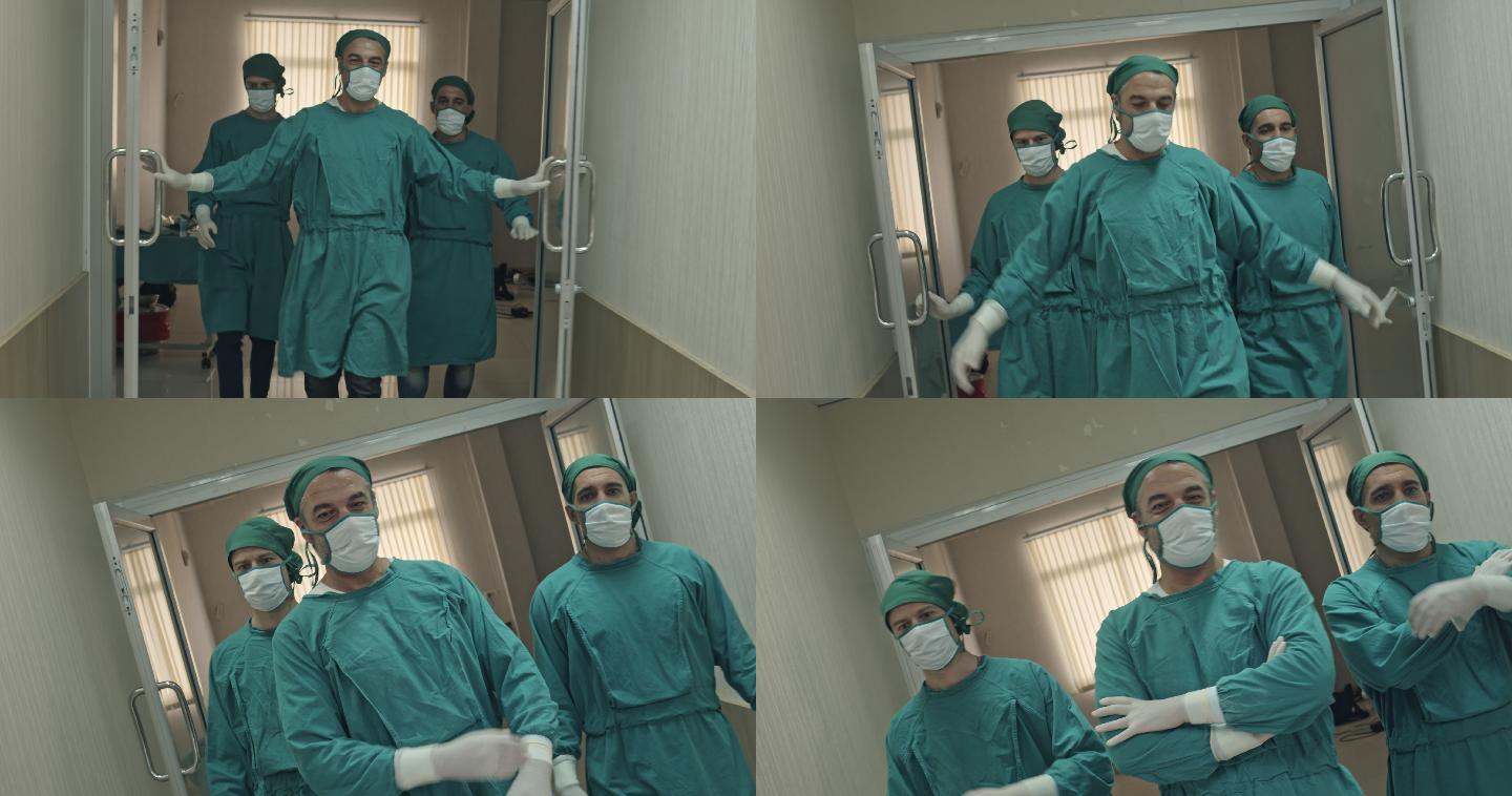 三名外科医生走出手术室看着摄像机