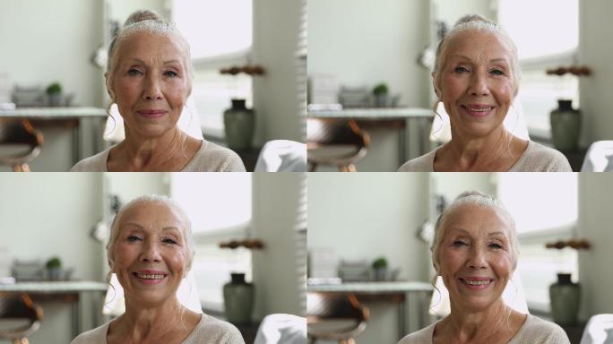 65岁快乐的老妇人看着镜头的特写