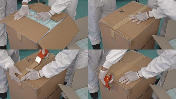 专业仓库工人检查并密封准备装运的纸箱