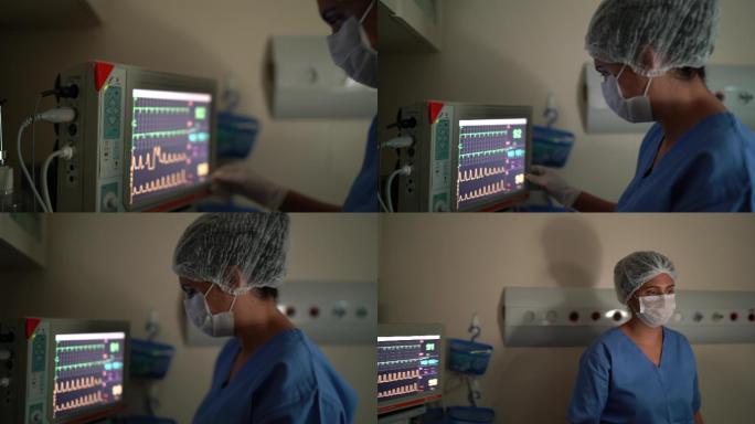 麻醉师分析医院手术中的计算机监视器