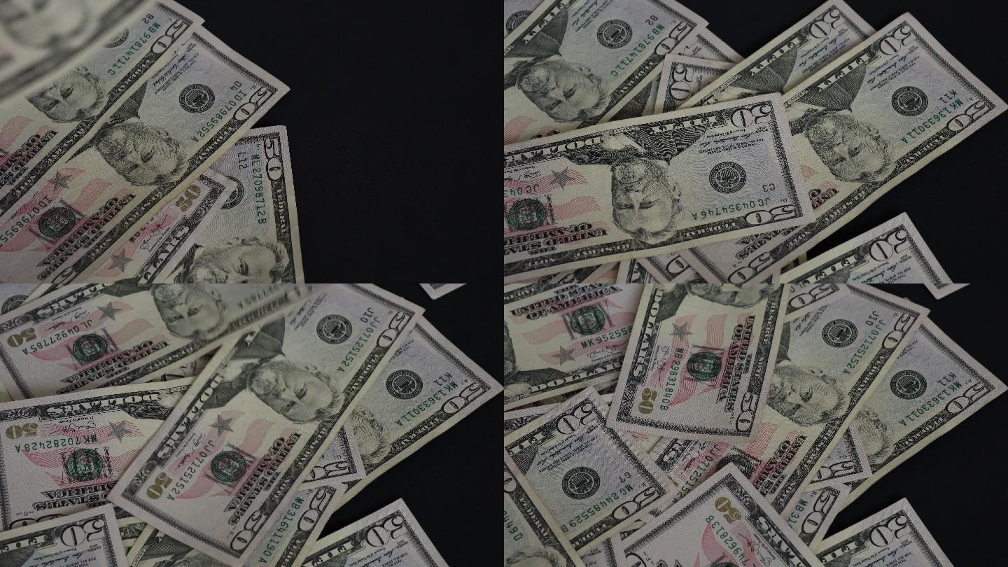 美国50美元钞票掉落在黑色地板上