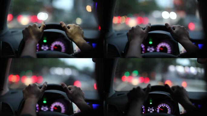 双手握着方向盘在城市里驾驶。