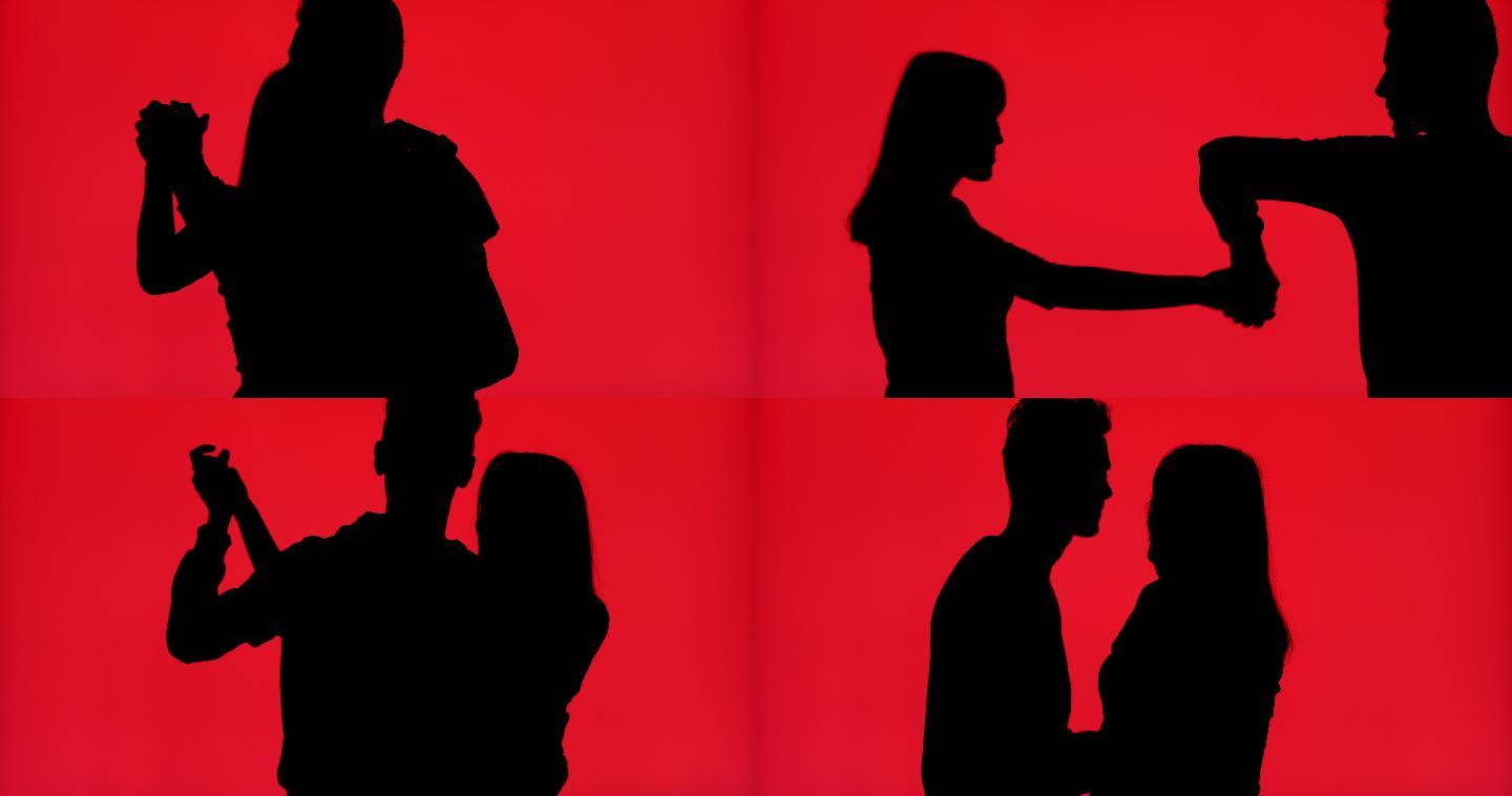 一对情侣在鲜红色背景下跳舞的剪影
