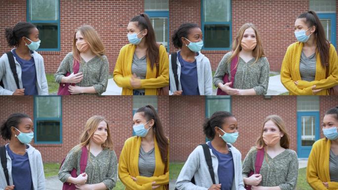 中学女生戴着口罩在户外散步聊天