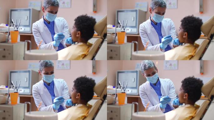 女牙医为小男孩做牙齿检查