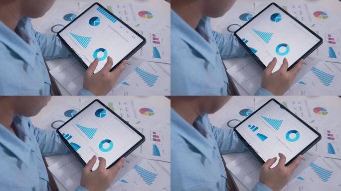 商人在数字平板电脑上查看商业年度报告