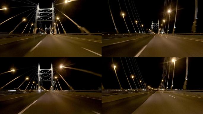 城市交通驾车第一视角开车过大桥桥上灯光照