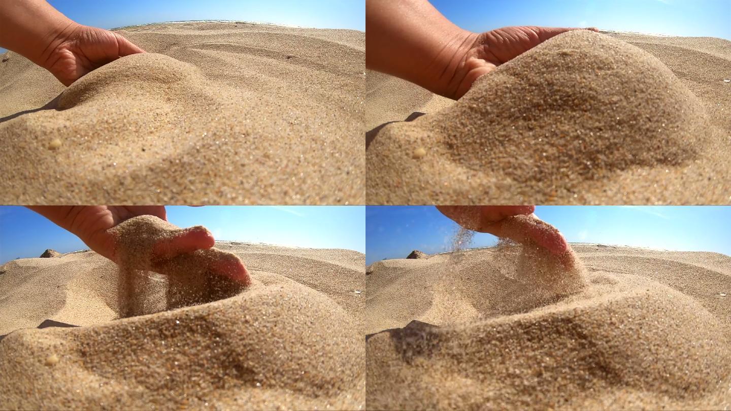 女孩在手掌中捡起一把沙子