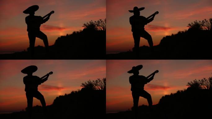 音乐家在日落背景下弹奏吉他的剪影