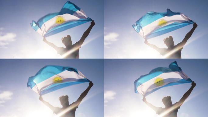 男子双手举着阿根廷国旗在海滩上翱翔