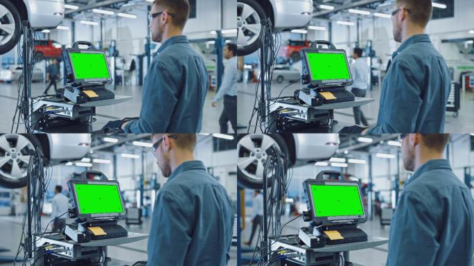 汽车维修技工在工厂使用绿色屏幕电脑