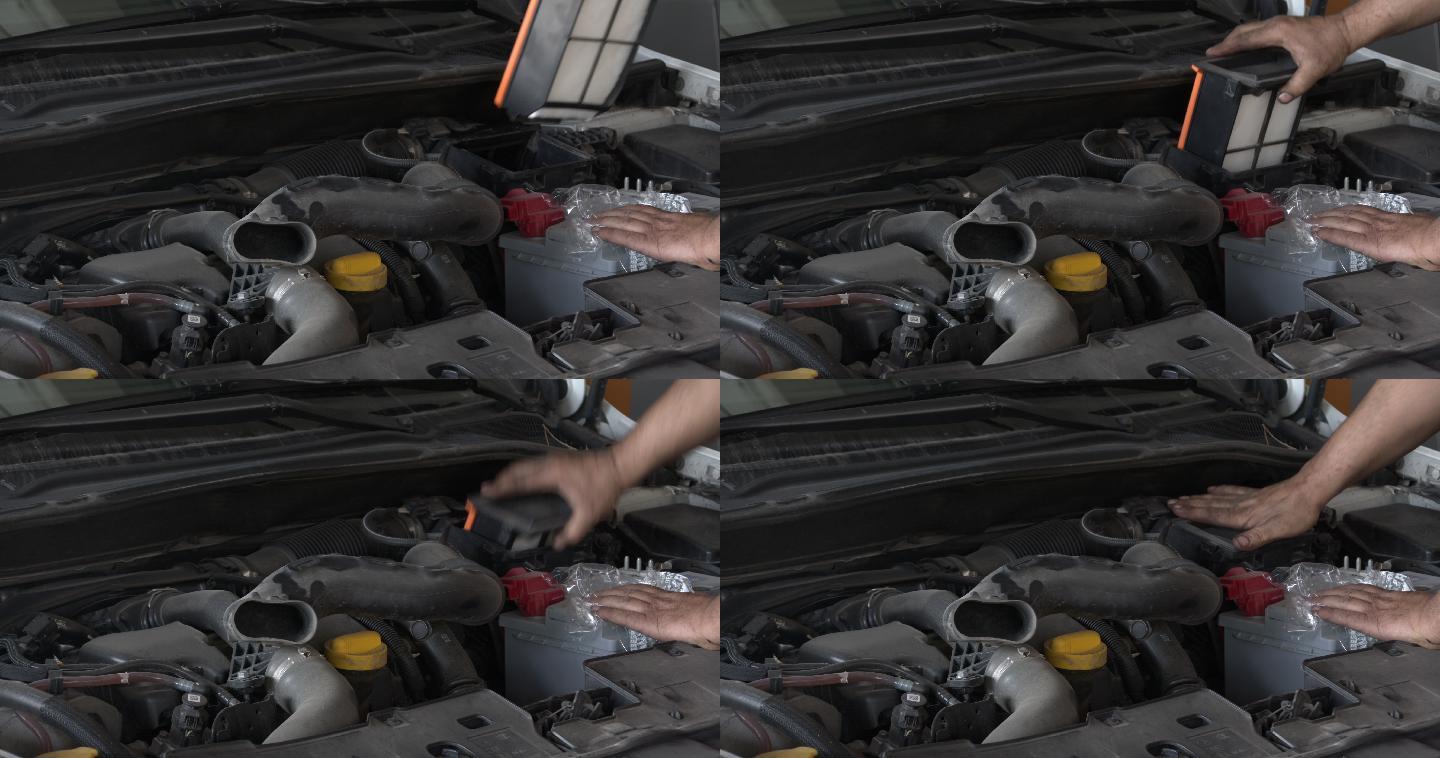 汽车维修工在车间更换汽车空气滤清器