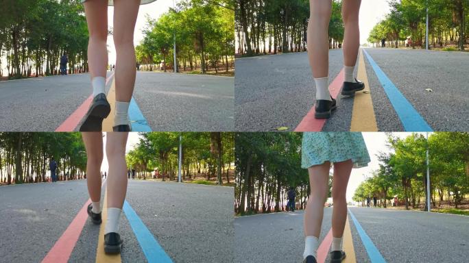 长腿美女孩在公园绿道上散步步伐脚步