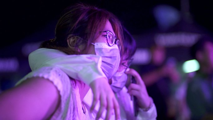 晚上音乐会派对上戴防护口罩的女性